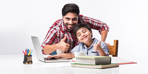 Online school in India concept - Cute little son taking father's help in studies or homework